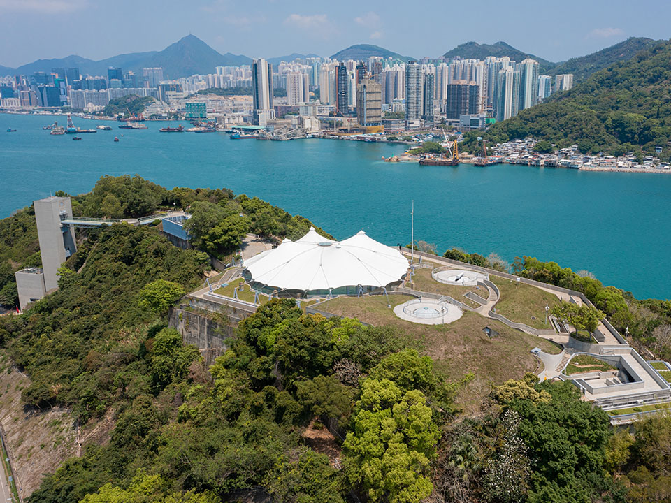 香港抗战及海防博物馆的空中拍摄图片，显示博物馆四周被树木包围，俯视鲤鱼门海峡。